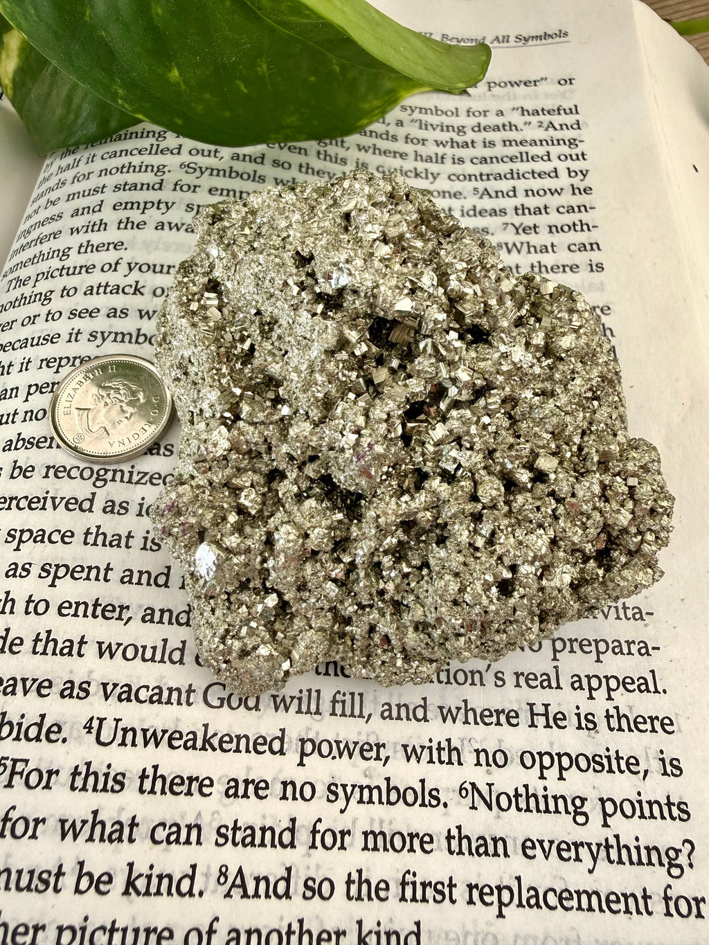 chunk of pyrite on book with dime to show scale 
