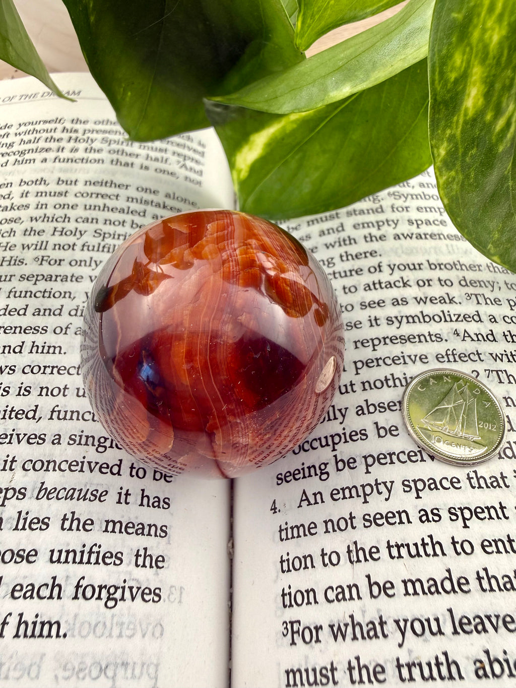 carnelian sphere beside dime to show size on book 