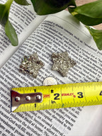 2 small pyrite stars with a measuring tape to show the size - approx 1"