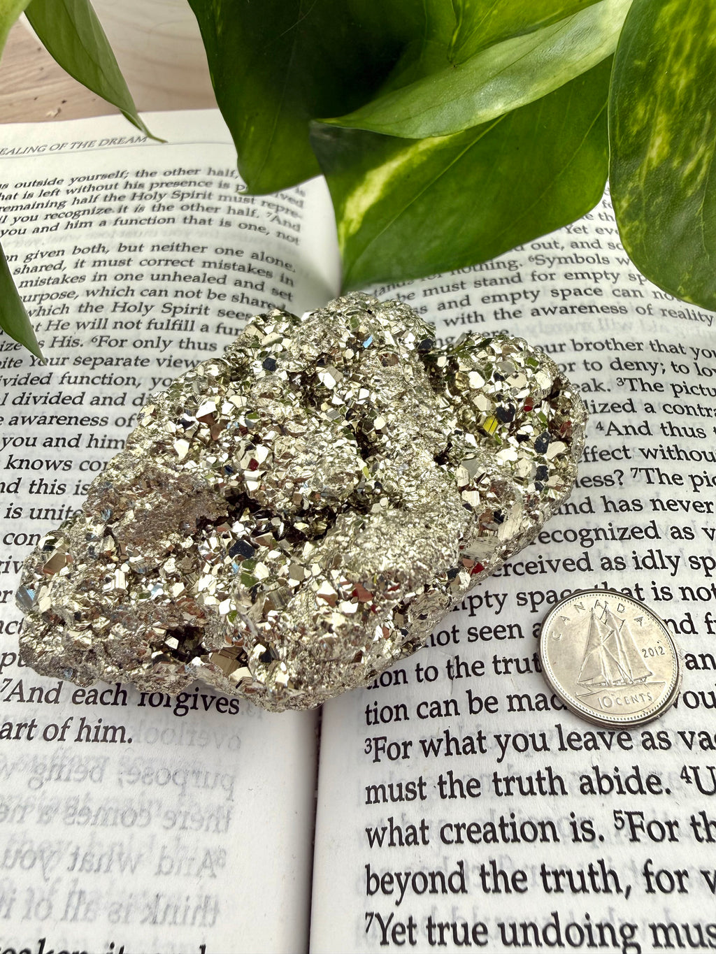Pyrite crystal with dime on a book 