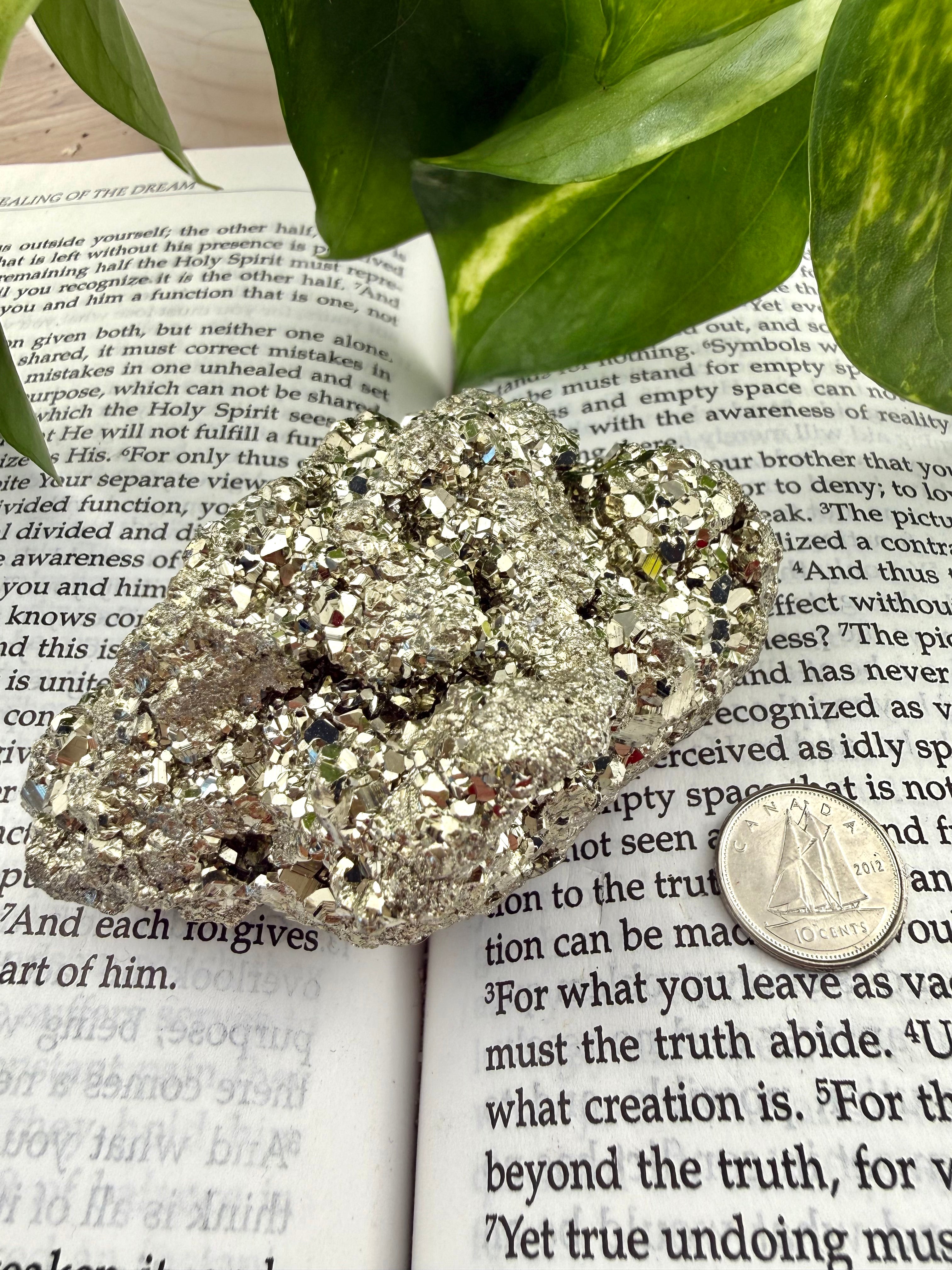 Pyrite crystal with dime on a book 