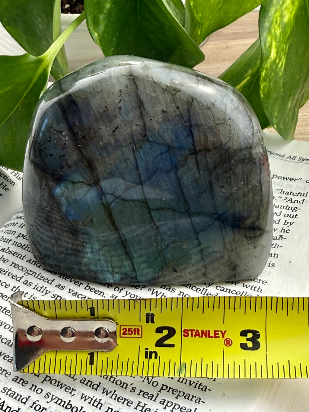 Labradorite stone with a ruler for scale on a magazine page