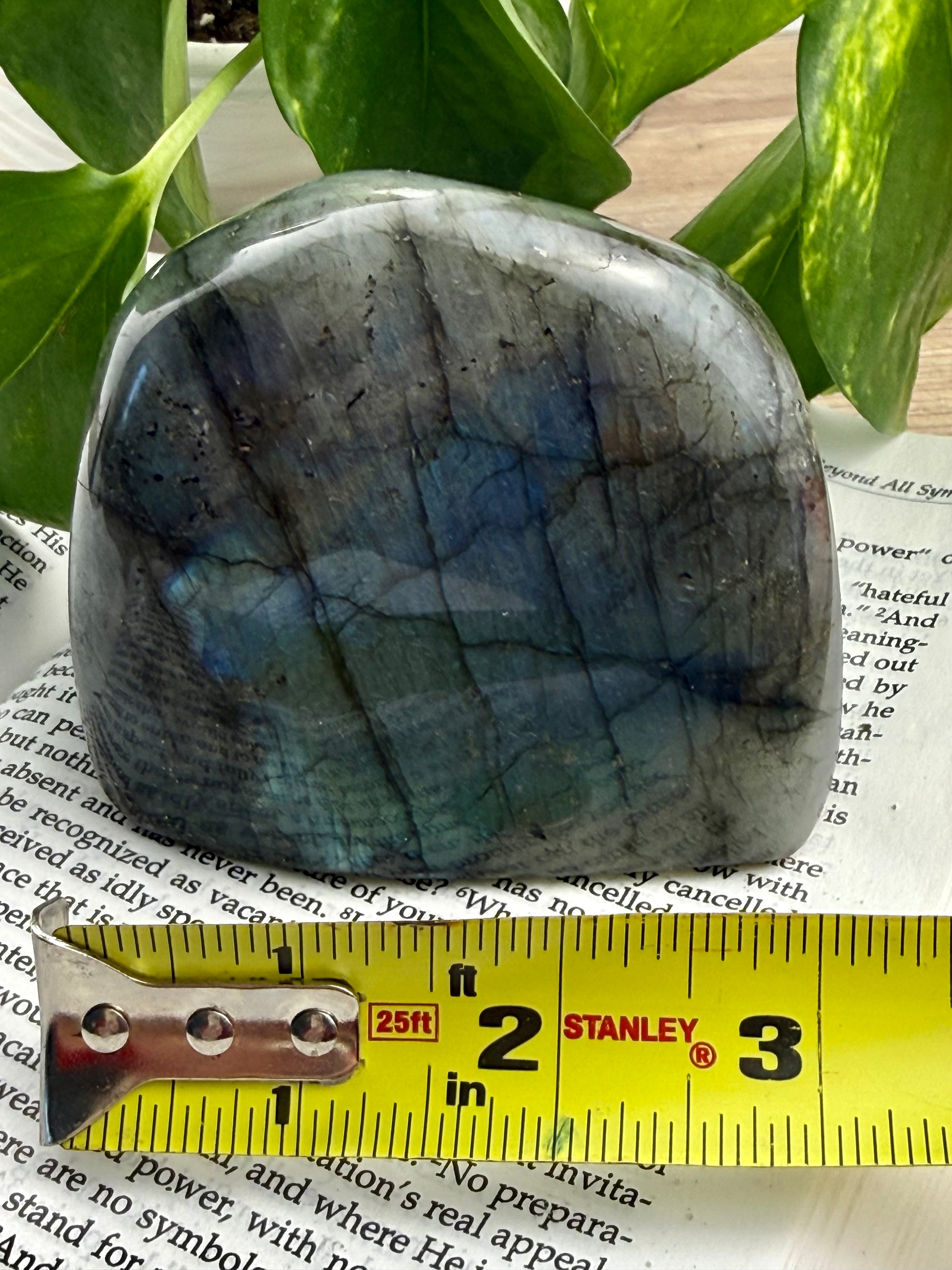 Labradorite stone with a ruler for scale on a magazine page