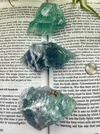 3 x fluorite crystals on an open book