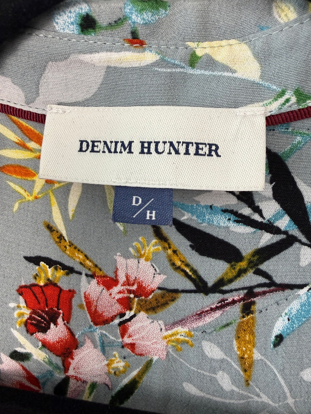 Denim Hunter label on a floral-patterned fabric