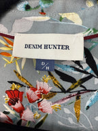 Denim Hunter label on a floral-patterned fabric