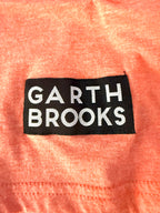 Detail image of Garth Brooks stitched logo patch on lower front hem.