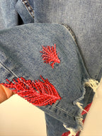 Dex embroidered feather skinny jeans medium wash distressed raw hem at Blue Sparrow Shop  close up of embroidery 