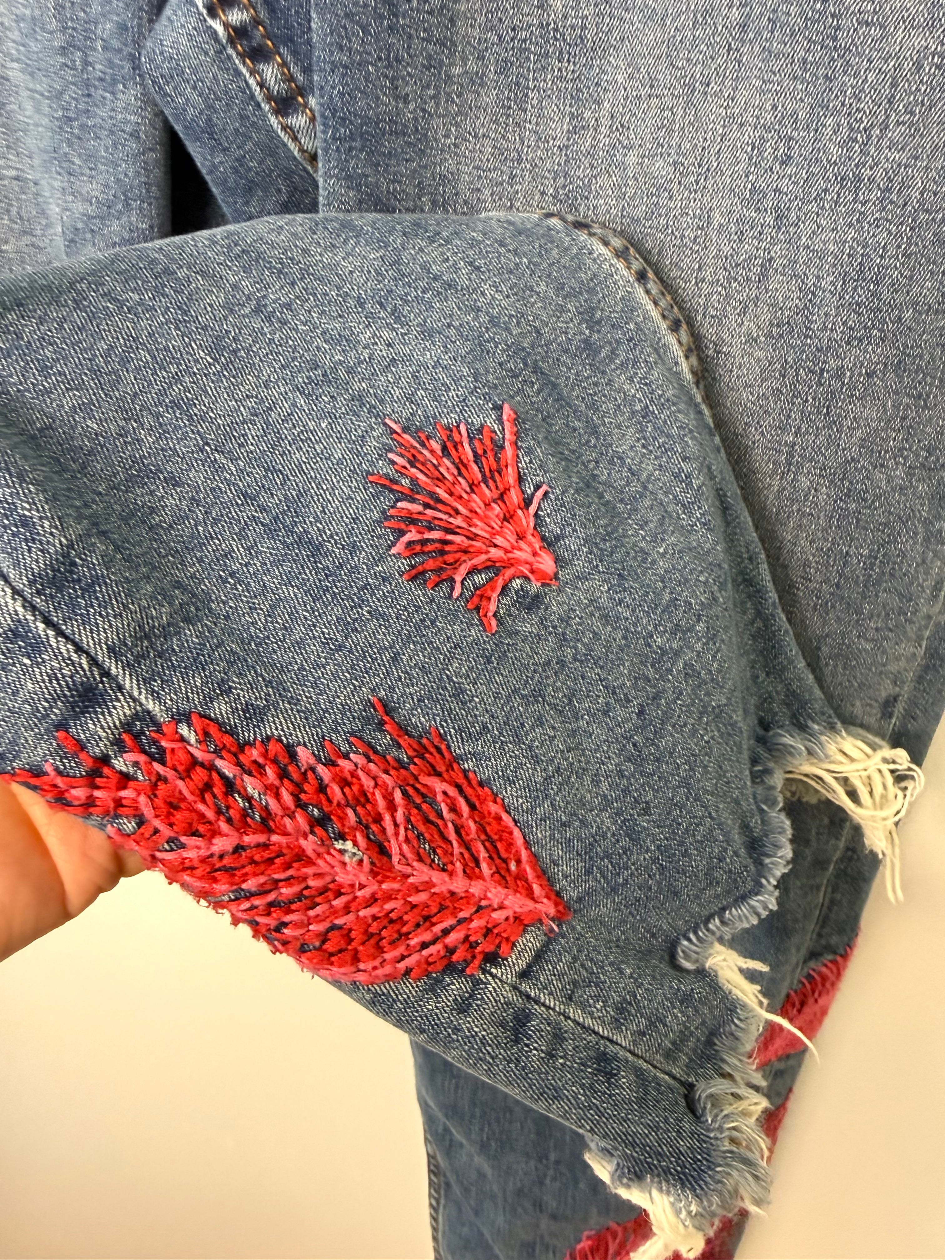 Dex embroidered feather skinny jeans medium wash distressed raw hem at Blue Sparrow Shop  close up of embroidery 