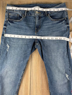 Dex embroidered feather skinny jeans medium wash distressed raw hem at Blue Sparrow Shop measuring 32" waist and 36" hips