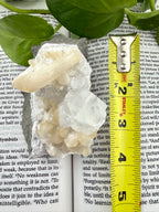 apophyllite showing a measuring tape that it's 4"long 
