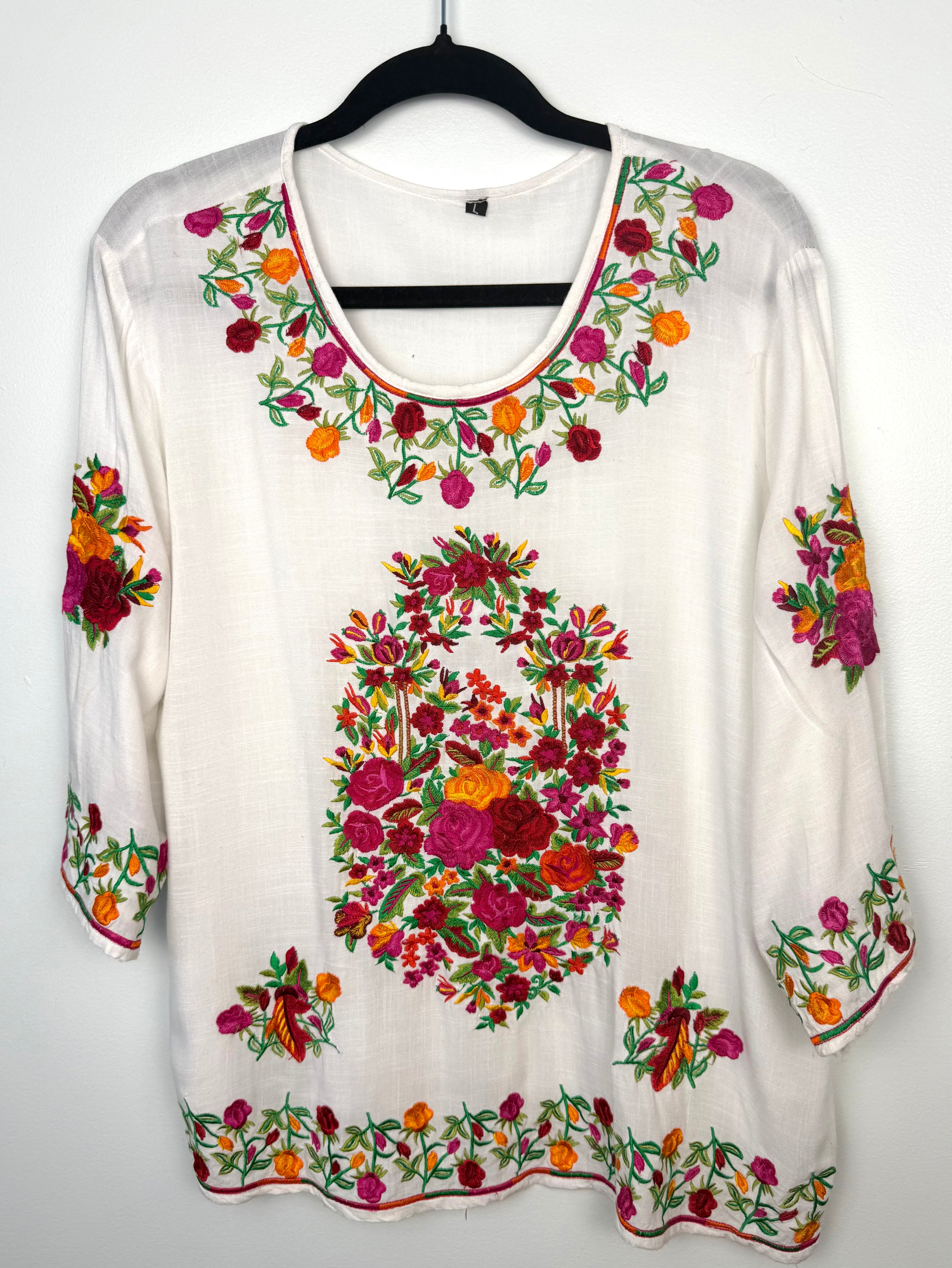 Embroidered Floral Tunic Blouse on hanger