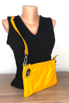 Enzo Bertini yellow leather crossbody bag with silver hardware and detachable strap, front view on mannequin