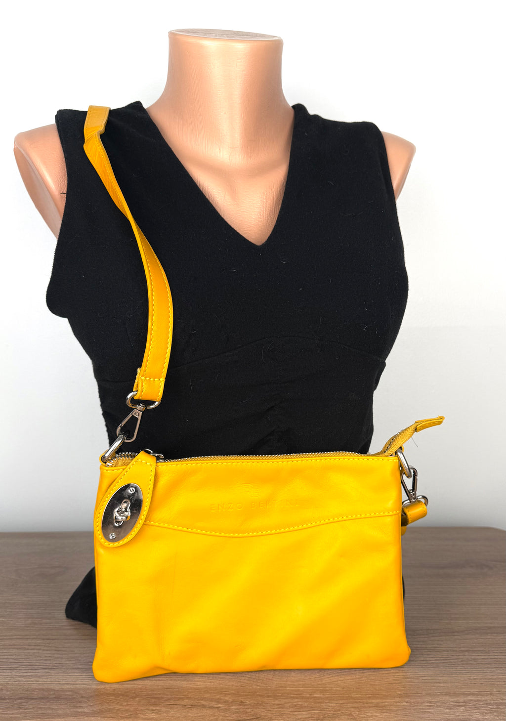 Enzo Bertini yellow leather crossbody bag with silver hardware and detachable strap, front view on mannequin 2