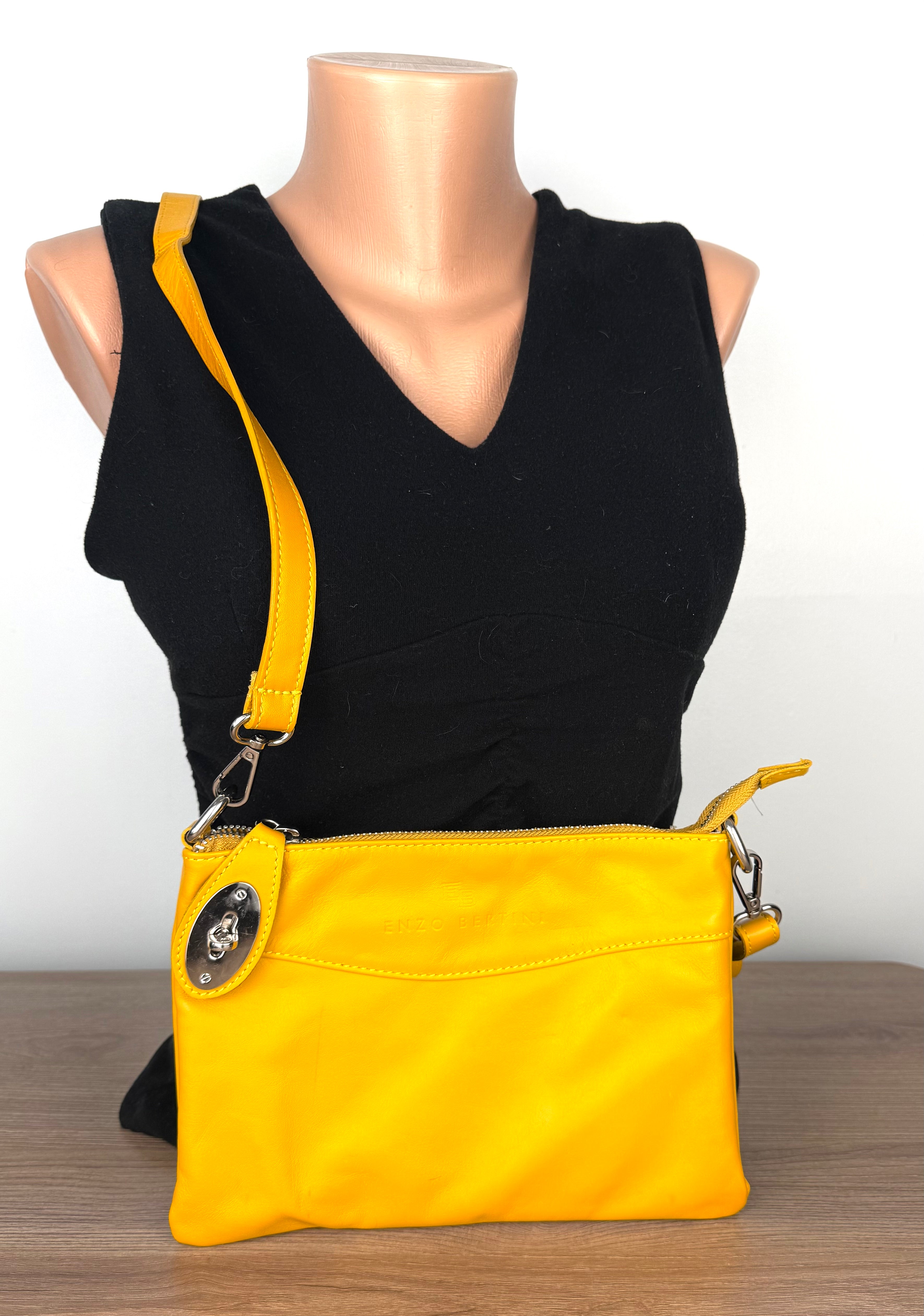 Enzo Bertini yellow leather crossbody bag with silver hardware and detachable strap, front view on mannequin 2