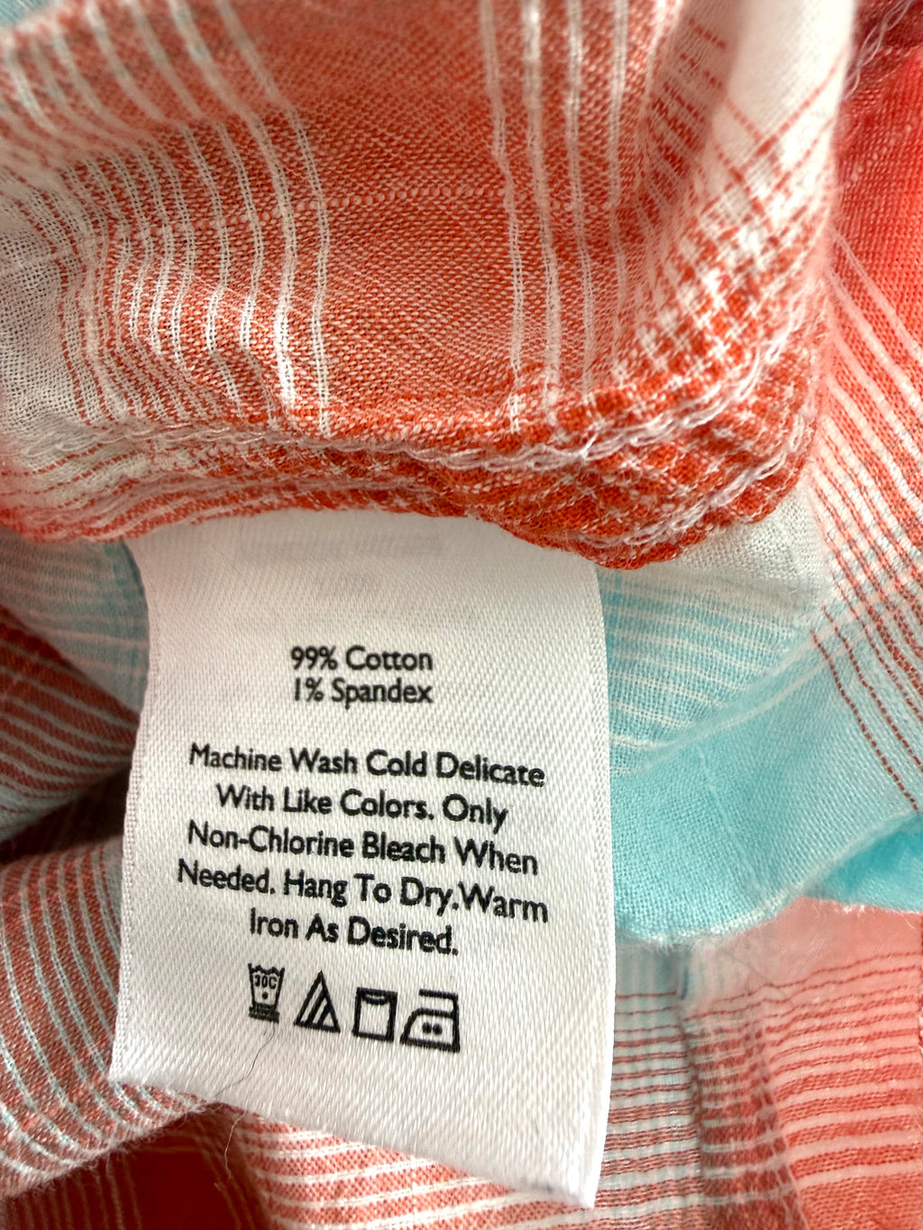 Fabric content tag showing 99% cotton, 1% spandex blend with care instructions.