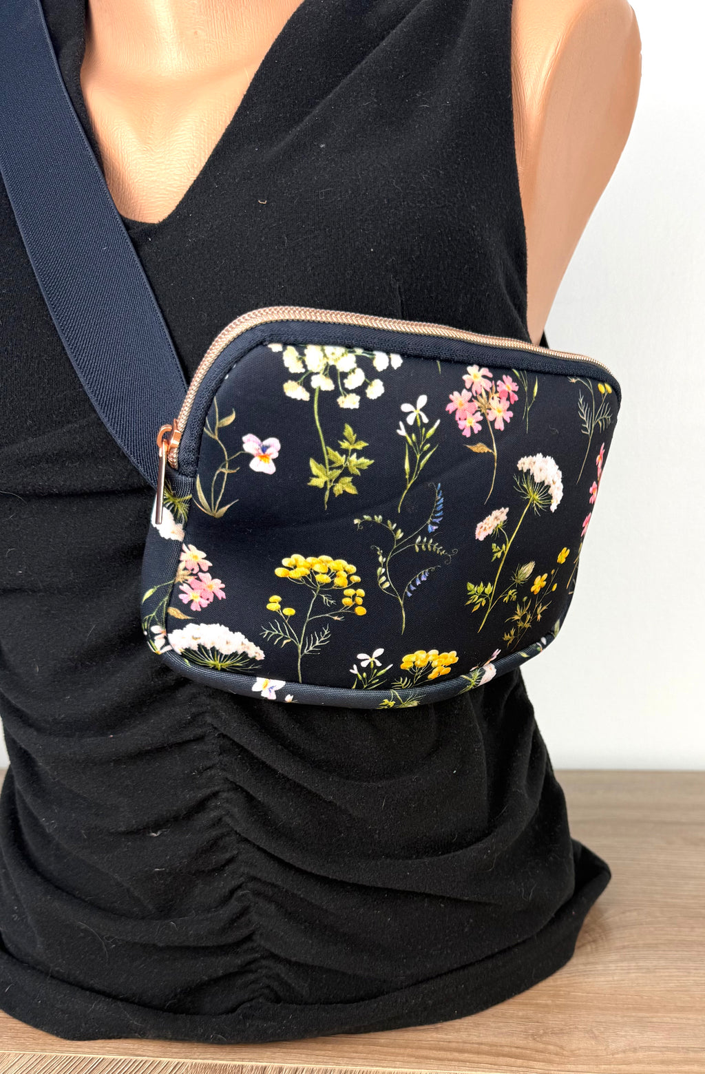 Floral cross body belt bag in navy on mannequin