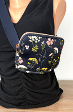 Floral cross body belt bag in navy on mannequin