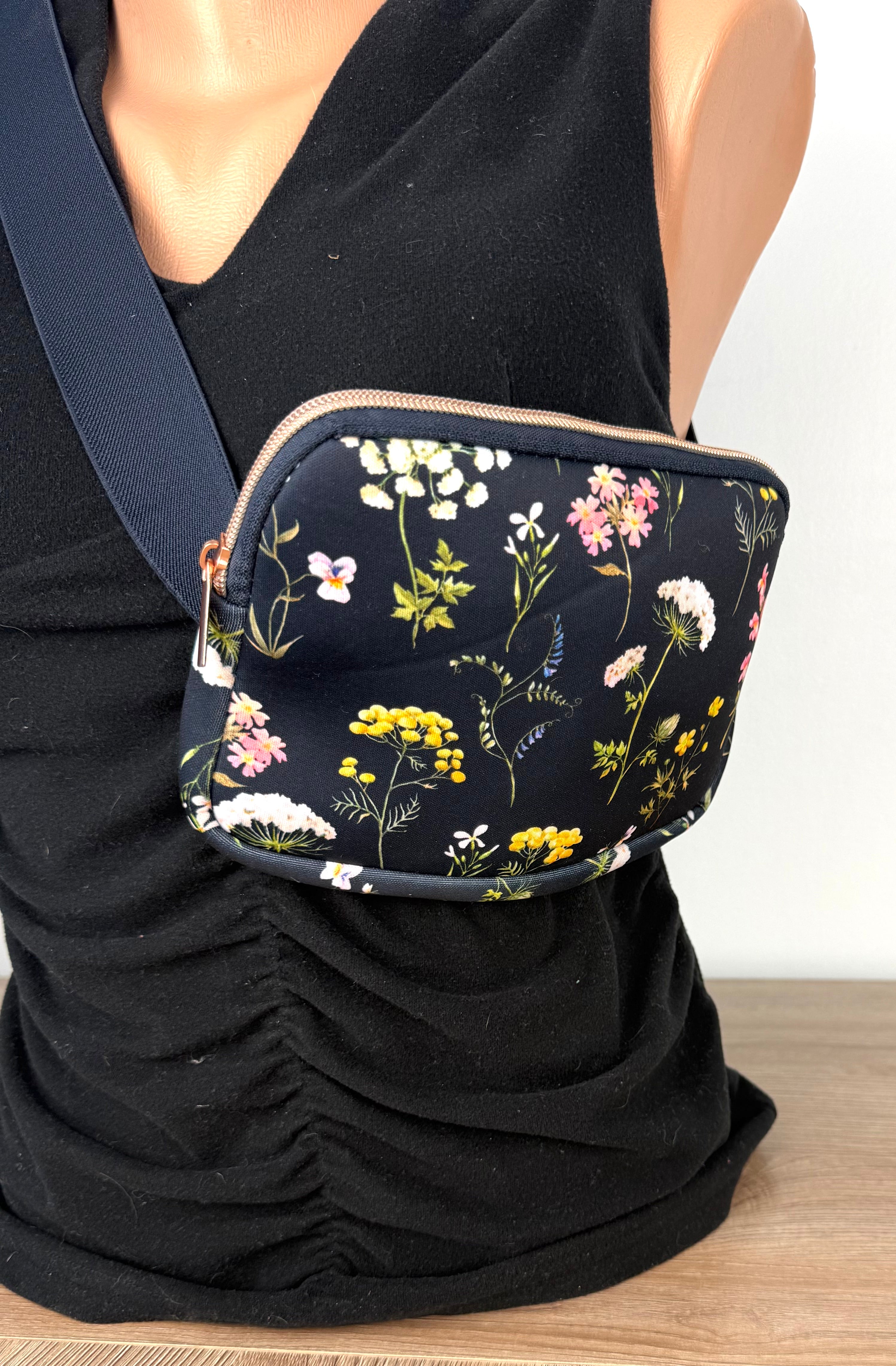 Floral cross body belt bag in navy on mannequin