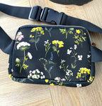 Floral cross body belt bag in navy laid flat
