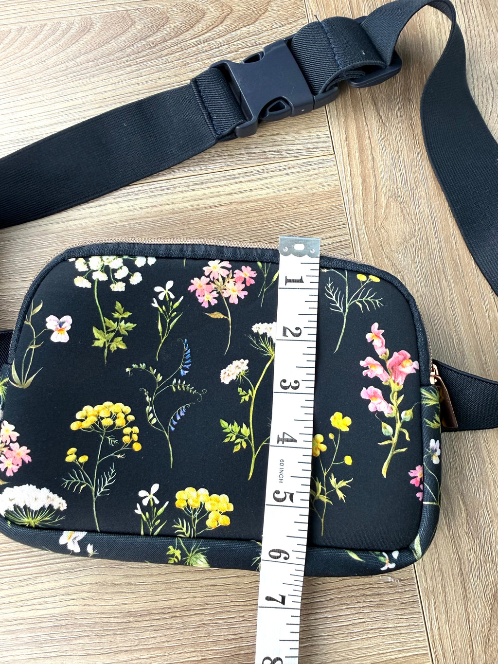 Floral cross body belt bag in navy measuring 6" deep 