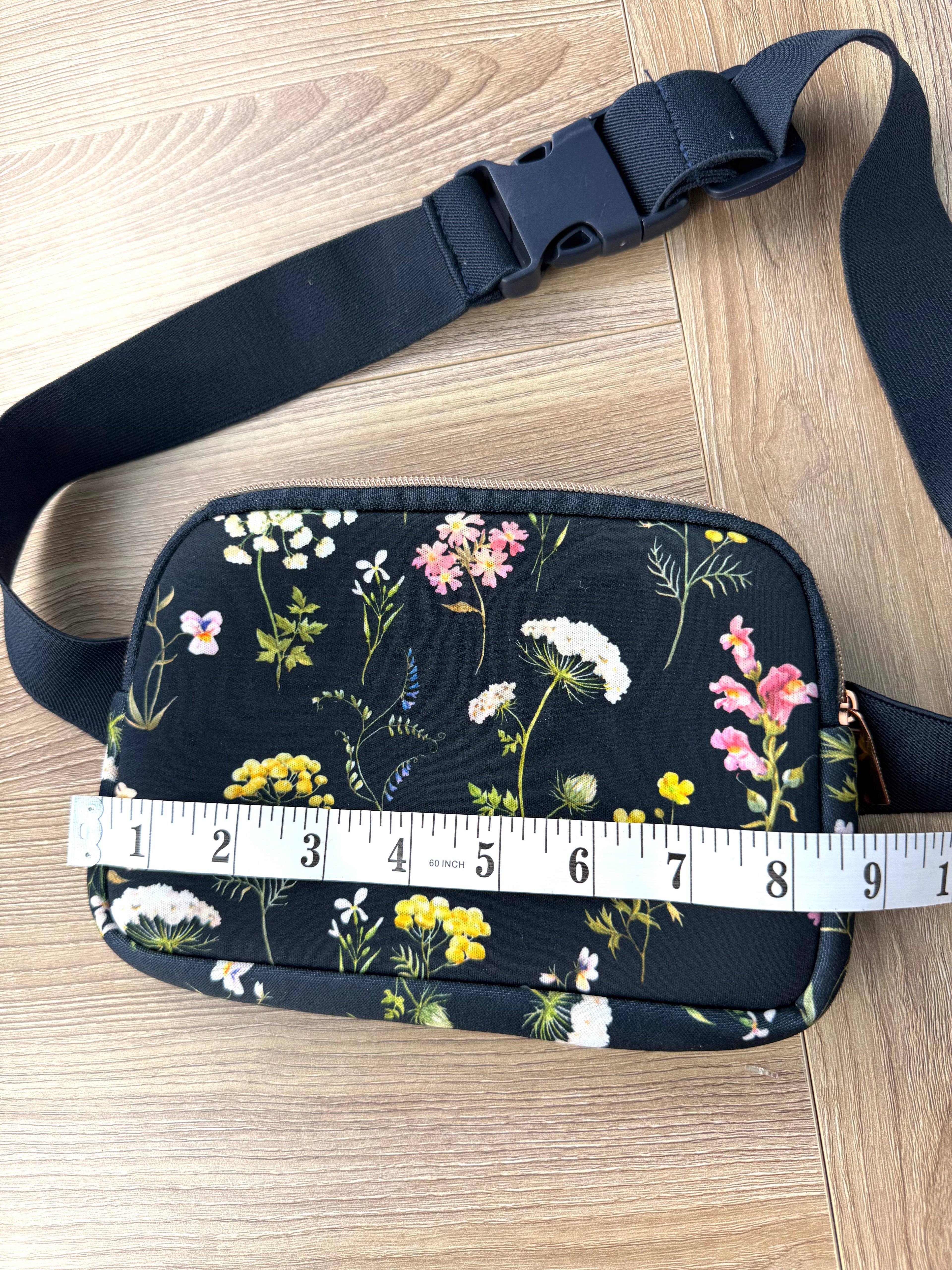 Floral cross body belt bag in navy measuring 8.5" wide
