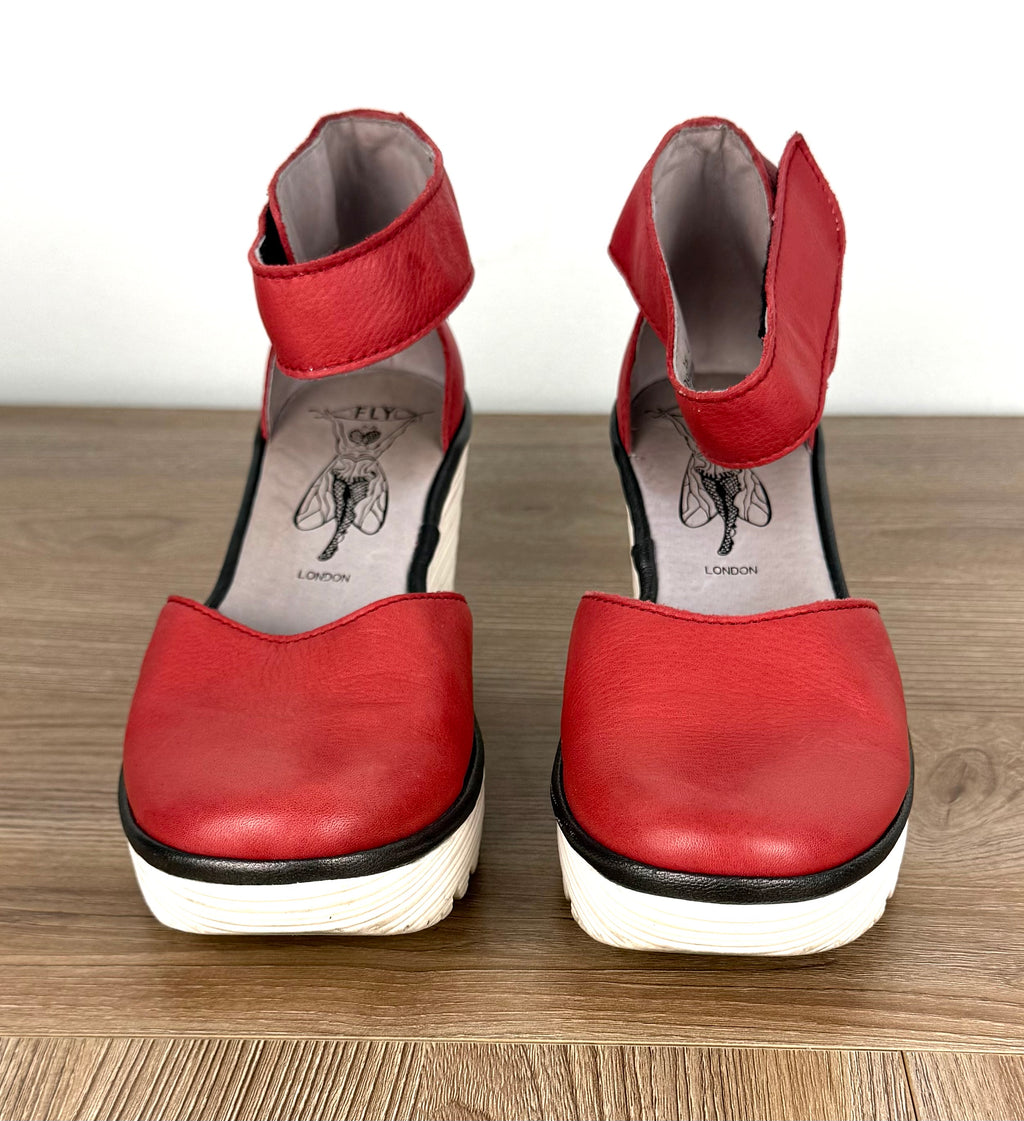 Fly London Red Leather Platform Wedge Sandals on table 