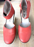 Fly London Red Leather Platform Wedge Sandals on table 