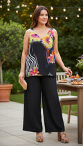 Frank Lyman — Bold Abstract Floral Sleeveless Top, Fully Lined, Size L at Blue Sparrow Shop on woman sitting outdoors at brunch 