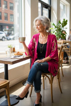 French Connection Floral Kimono | Romantic Boho Layering Piece at Blue Sparrow Shop on woman wearing jeans and heels drinking coffee in cafe