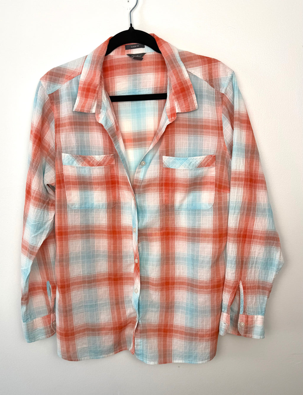 Front view of Eddie Bauer women’s classic fit plaid button-down shirt in coral and aqua, long sleeve cotton blend, size XL.