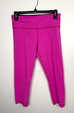 Front view of hot pink Lululemon high-rise cropped leggings