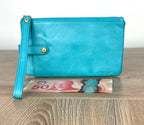 Turquoise HOBO Evolve leather wristlet clutch with gold hardware and detachable strap shown next to Canadian $50 bill for size reference.