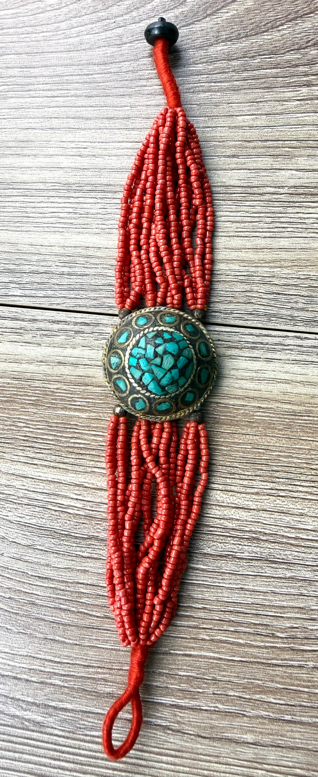 Red multi strand seed bead bracelet with turquoise inlay medallion centre artisan boho style jewellery