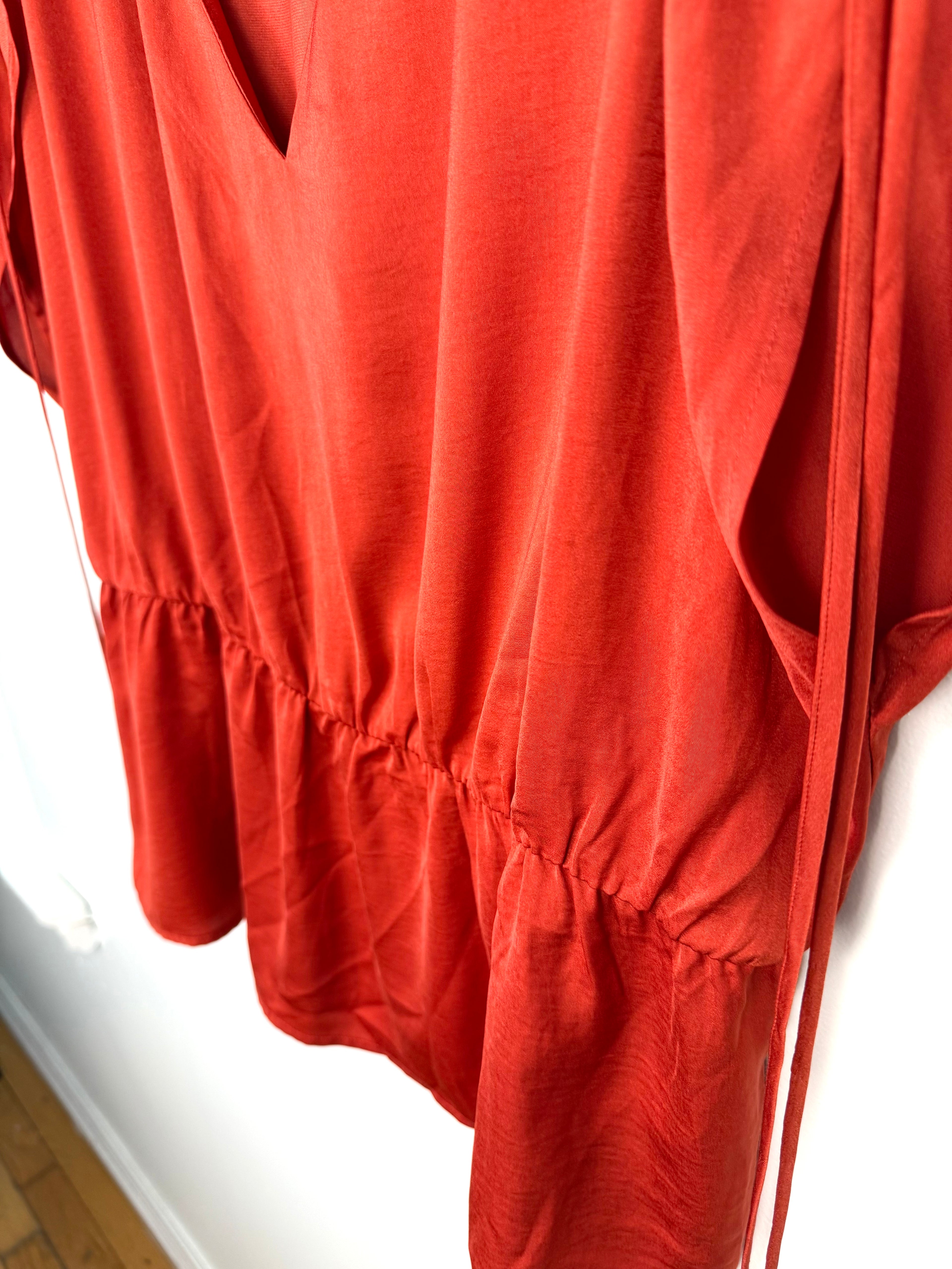 Gathered waist detail on back of Banana Republic peplum top in rust 