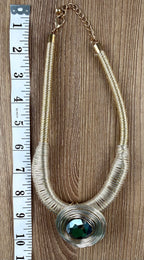 Gold-tone wire coil statement necklace with dark green faceted crystal pendant, laid flat with measuring tape, full length view — Blue Sparrow pre-loved jewellery