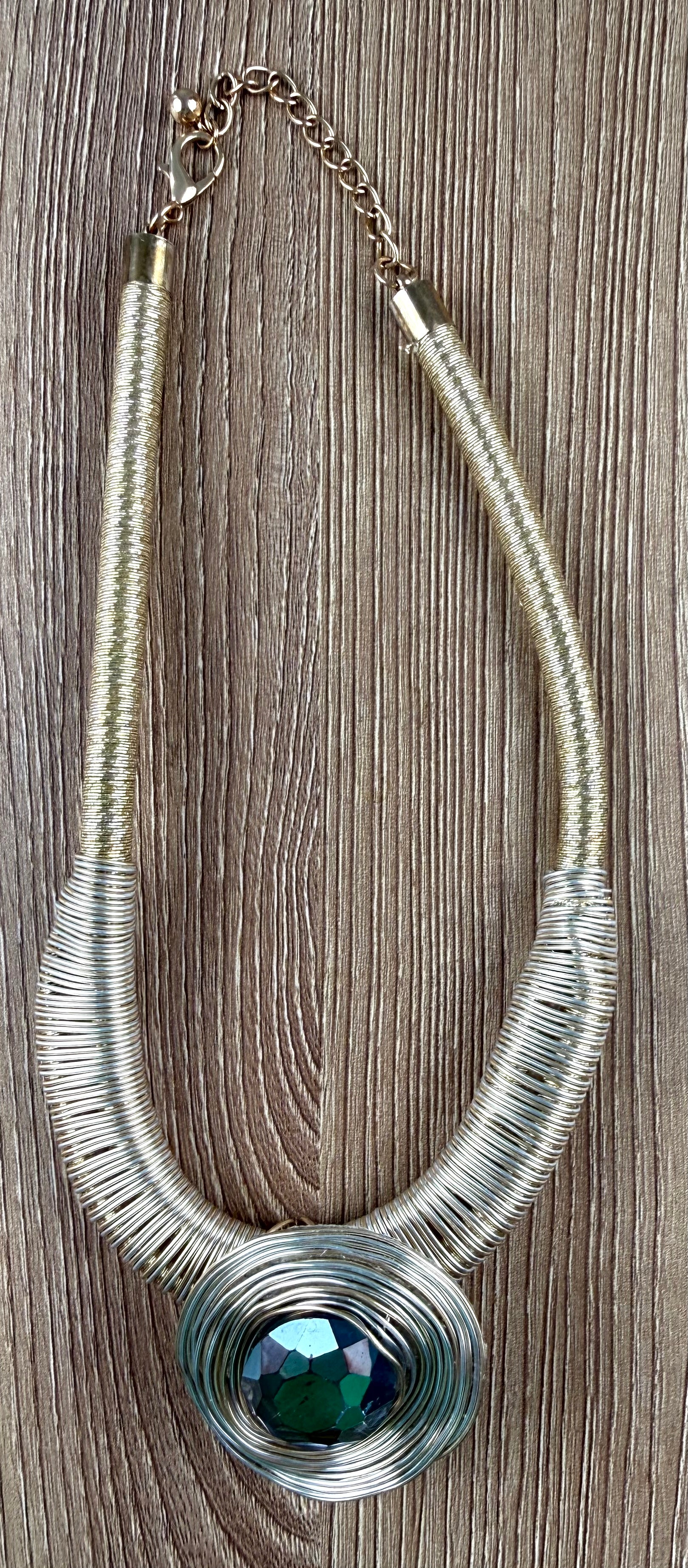 Gold-tone wire coil statement necklace with dark green faceted faux crystal pendant at Blue Sparrow Shop
