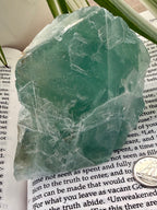 Green fluorite crystal on top of a book