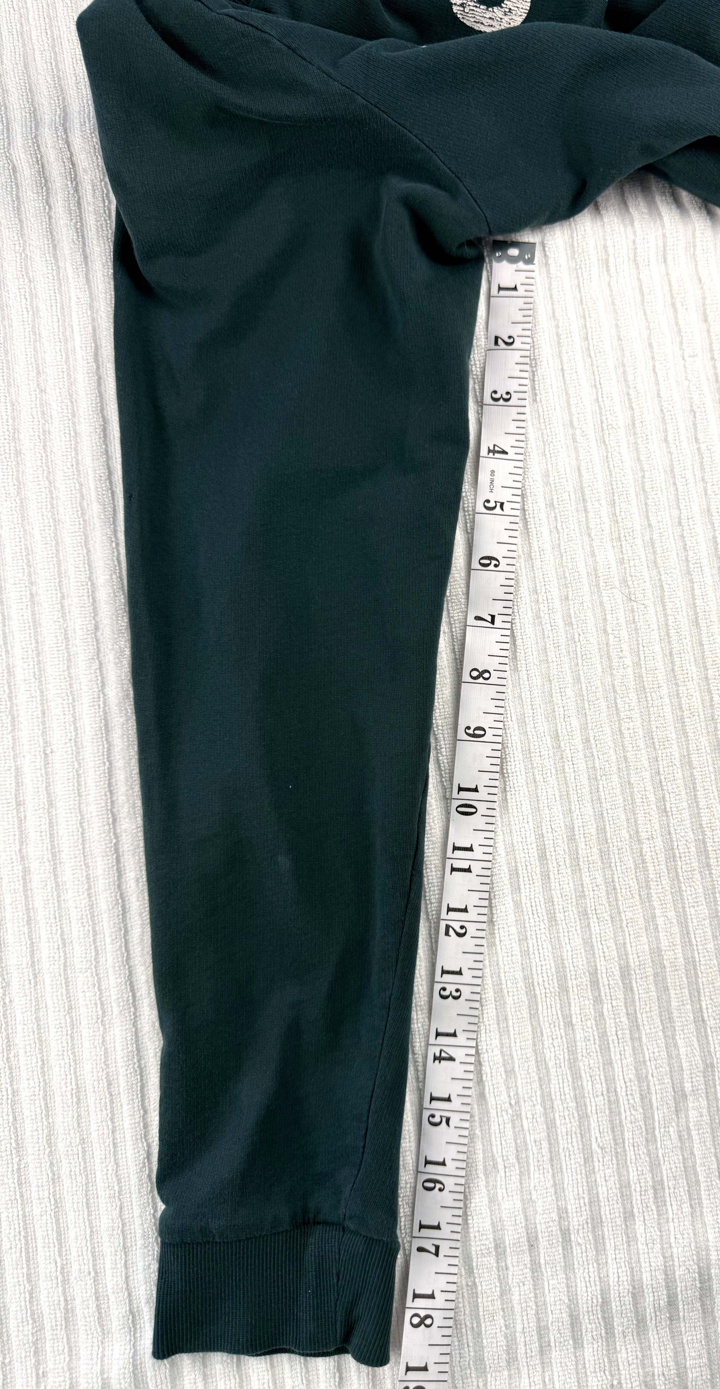 H&M Divided teal green 100% cotton graphic crew neck sweatshirt with "Property of No One" distressed white lettering, front view on hanger — Blue Sparrow pre-loved women's fashion measuring 19" sleeve 