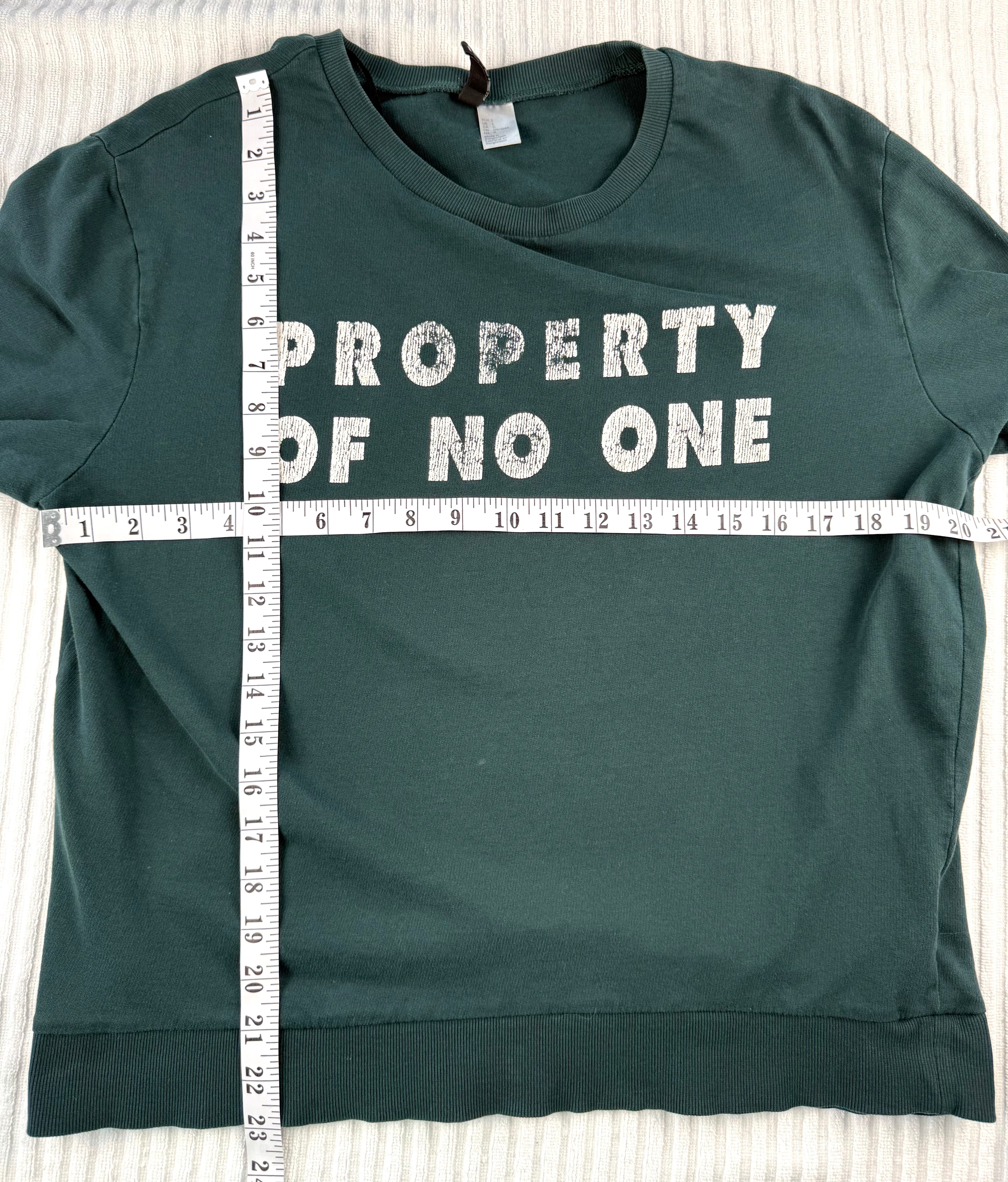 H&M Divided teal green 100% cotton graphic crew neck sweatshirt with "Property of No One" distressed white lettering, front view on hanger — Blue Sparrow pre-loved women's fashion measuring 40" bust and 23" shoulder to hem 
