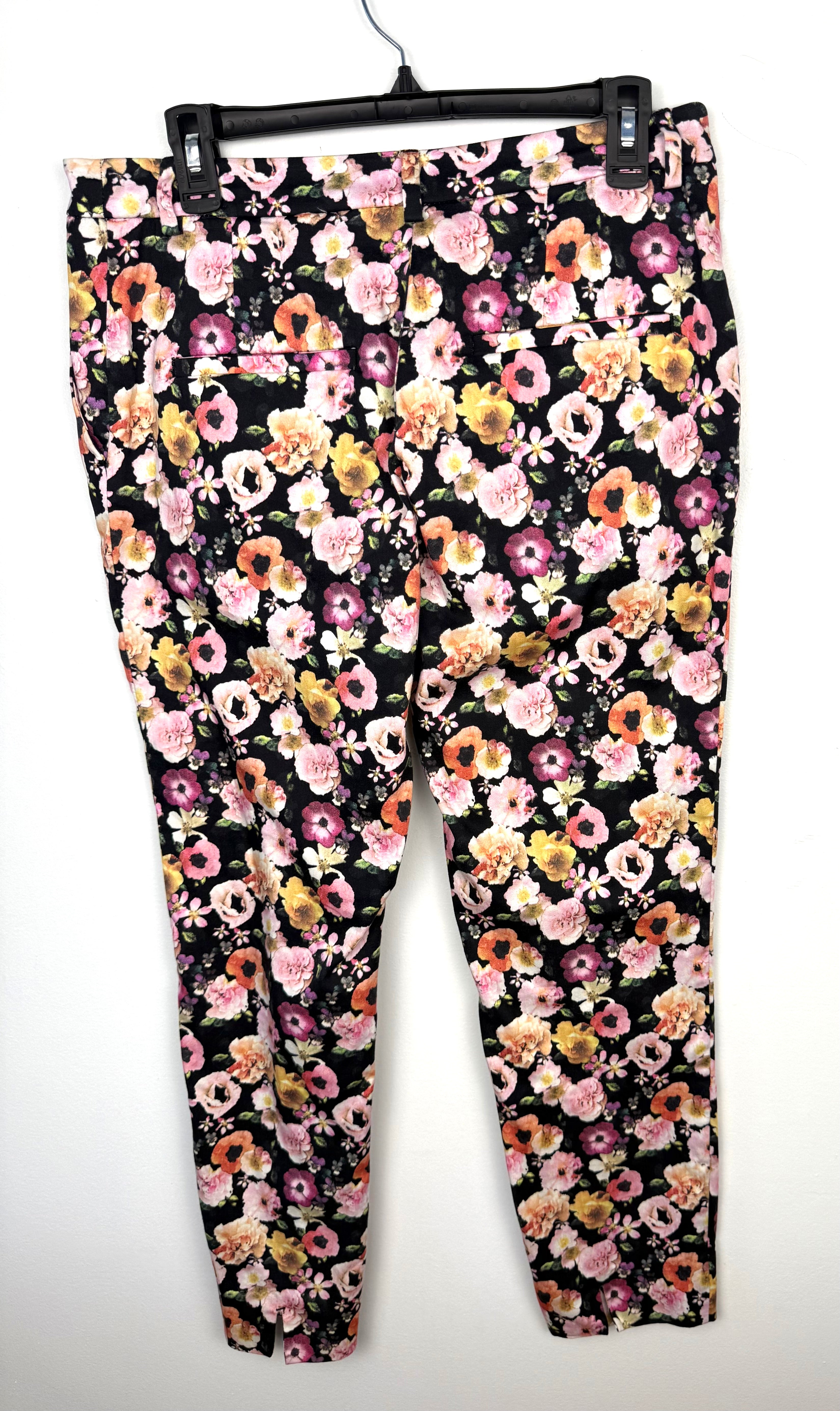 back of H&M Slim Fit Ankle Pants with floral pattern on hanger