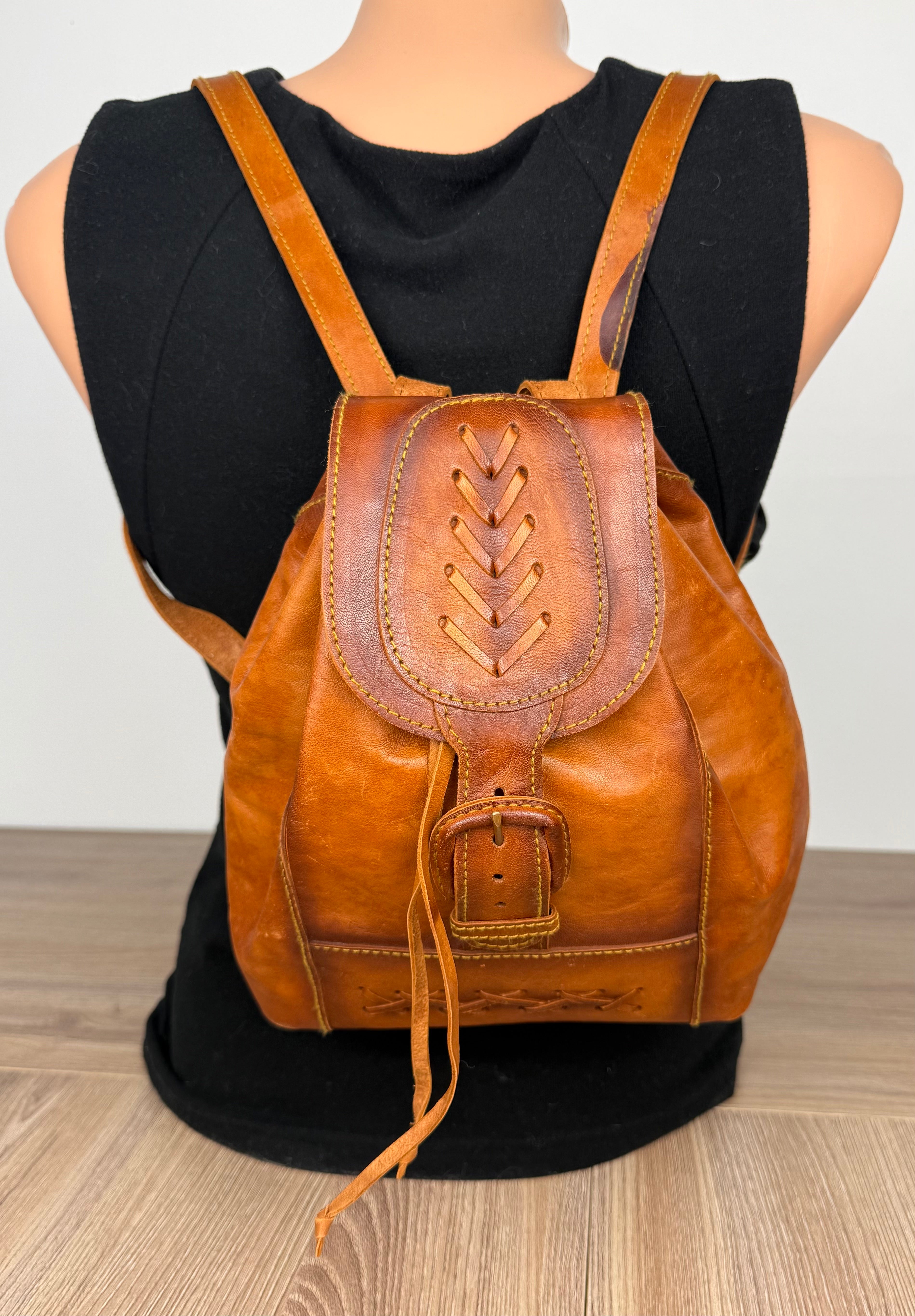 Handcrafted Artisan Boho Leather Rucksack shown on the back of mannequin 