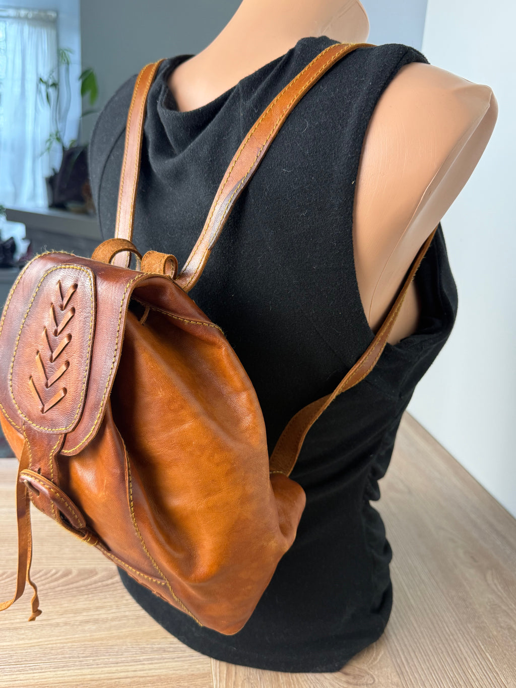 Handcrafted Artisan Boho Leather Rucksack shown on the back of mannequin side view