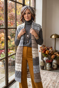 Handmade Long Vest | Size S on woman wearing mustard pants standing by window