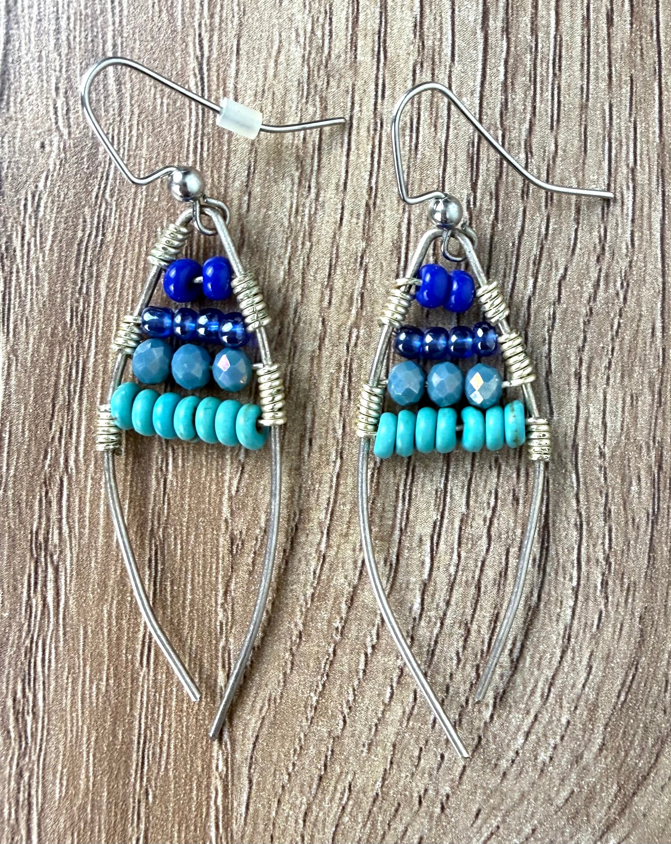 Handmade Wire Wrapped Turquoise Beaded Earrings on table 