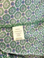 Inside label Max Studio ss top with geometric pattern in green and blue 100% polyester