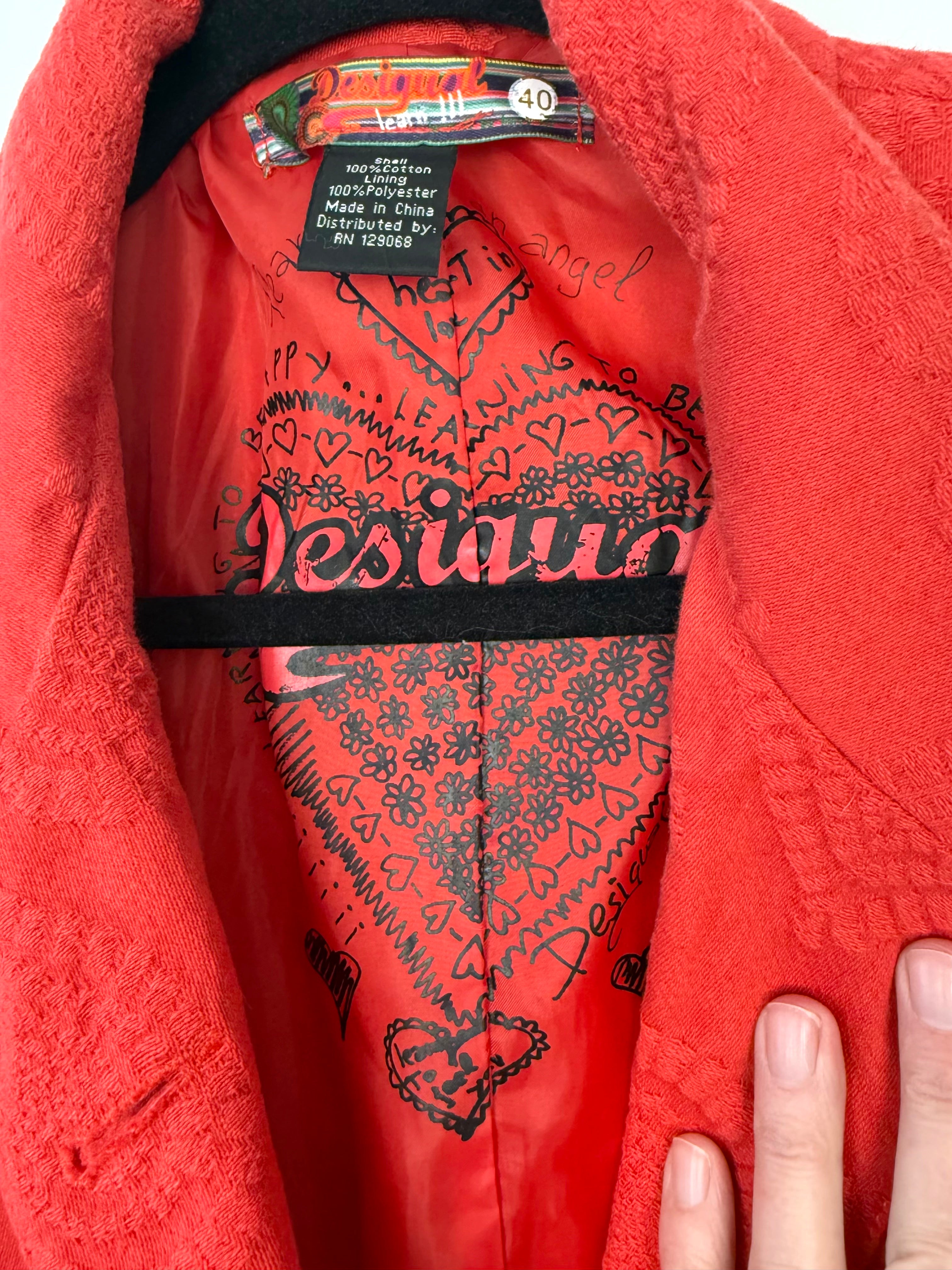 Inside of Desigual Y2K red jacket with embossed hearts pattern