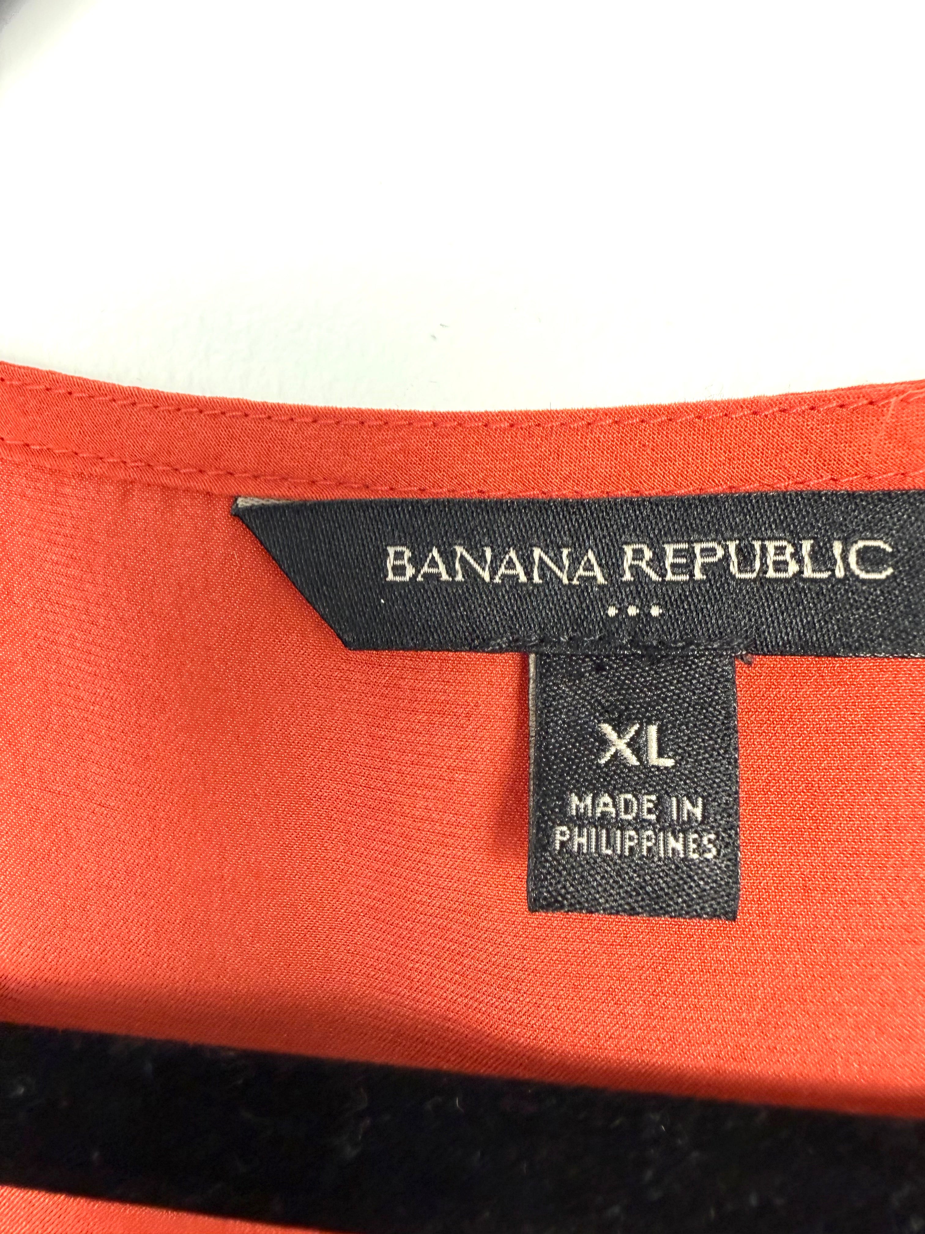 Inside tag on  Banana Republic peplum top in rust  size XL made in Phillipines 