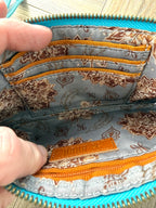 HOBO Evolve wristlet interior with multiple card slots, zip pocket, and patterned lining.
