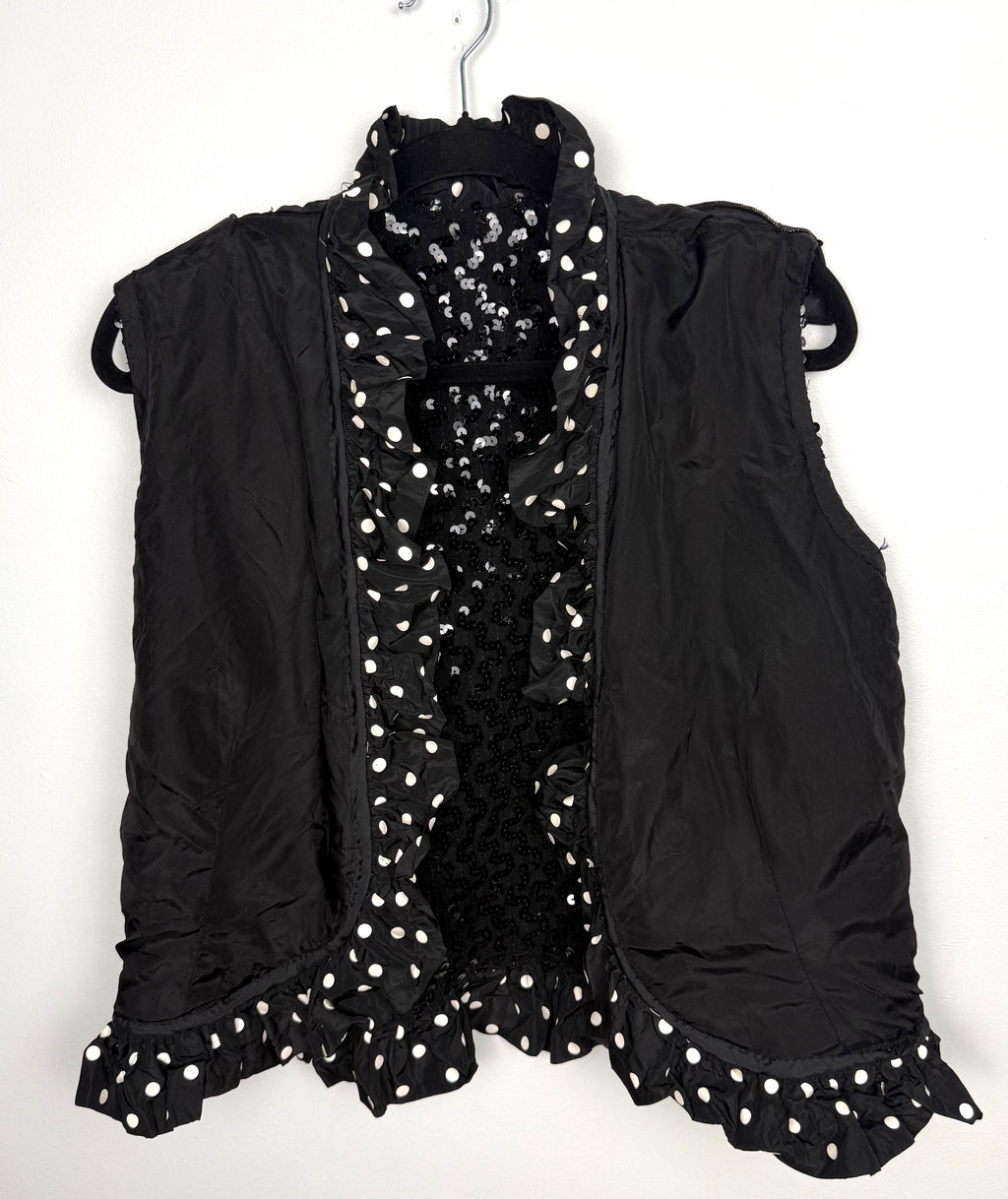 Interior lining and ruffle trim detail black vest